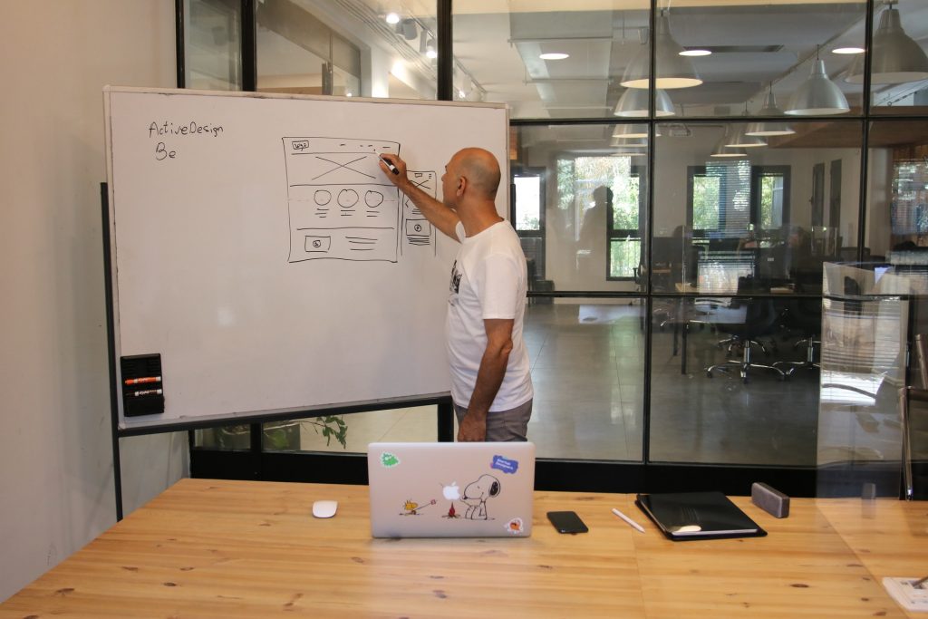 entrepreneur analyzing project standing near whiteboard